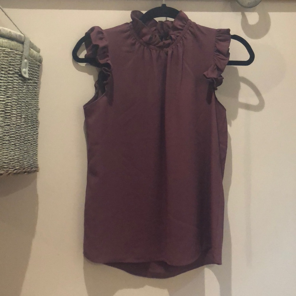 Mauve top with ruffle accent.